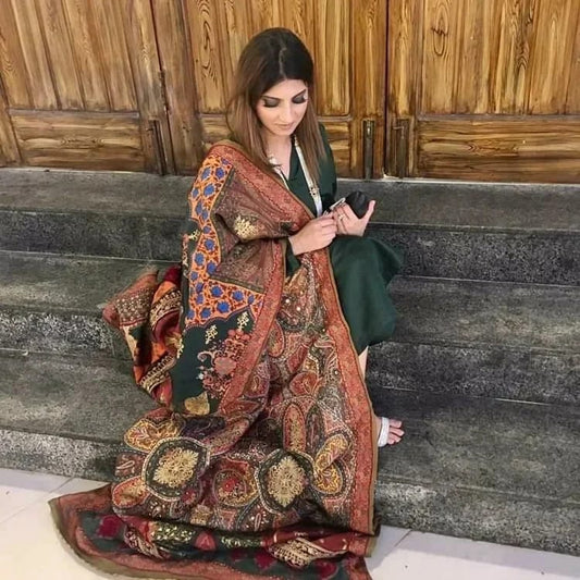 "Bundhani " charmeuse silk statement piece gives this attire an unusual traditional twist Features subtle hue and intricate embroideries. Theme silk shawl